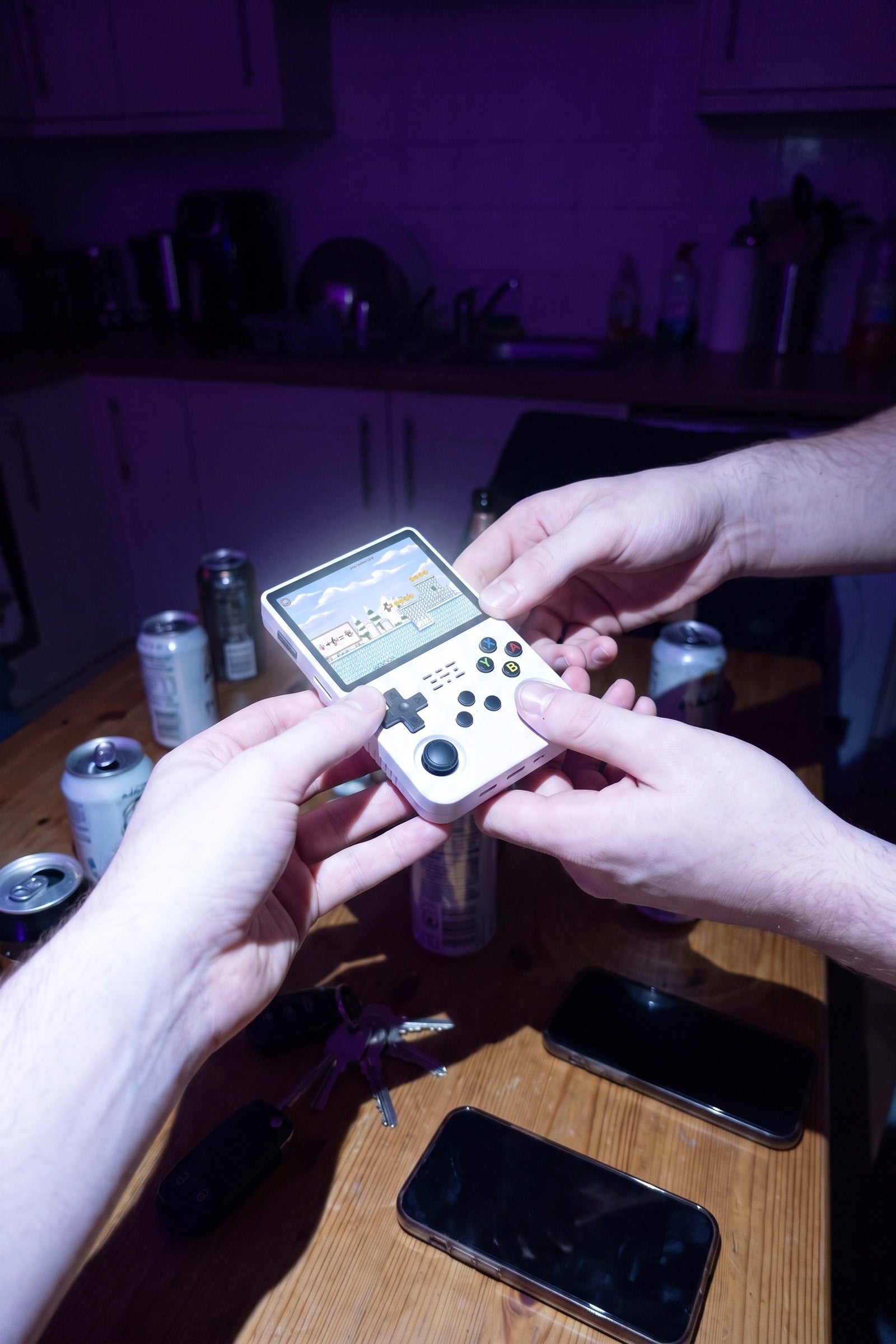 Two hands passing the Turn One across a kitchen table at night