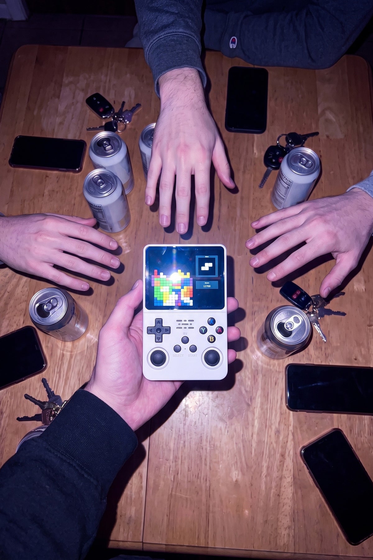 Four hands reaching for the Turn One on a table